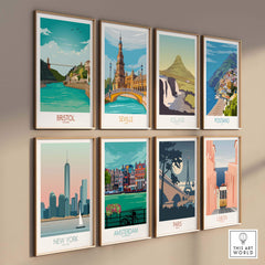 Vintage travel posters of Bristol, Seville, Iceland, Positano, New York, Amsterdam, Paris, and Lisbon on a gallery wall.