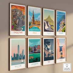 Collection of vintage travel art prints featuring Cinque Terre, Seville, Iceland, Positano, New York, Amsterdam, Paris, and Lisbon.