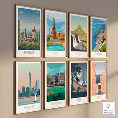 Framed art prints of Florence, Seville, Iceland, Positano, New York, Amsterdam, Paris, and Lisbon on a wall.