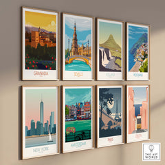 Gallery wall of vintage-inspired travel posters featuring Granada, Seville, Iceland, Positano, New York, Amsterdam, Paris, and Lisbon.