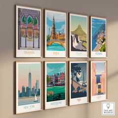 Collection of vintage travel poster prints including Granada, Seville, Iceland, Positano, New York, Amsterdam, Paris, and Lisbon.