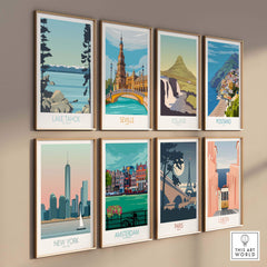A collection of vintage-inspired travel prints featuring Lake Tahoe, Seville, Iceland, New York, and more, hung on a wall.