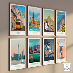 Wall art display featuring travel posters of Lisbon, Seville, Iceland, Positano, New York, Amsterdam, Paris.