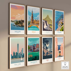 Wall display of vintage travel prints featuring San Juan, Seville, Iceland, Positano, New York, Amsterdam, Paris, and Lisbon.