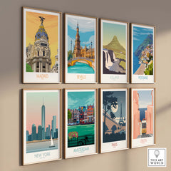 Framed vintage travel art prints featuring cities like Seville, Madrid, and Paris on a stylish wall display.