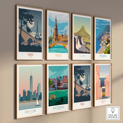 Collection of vintage travel posters featuring Paris, Seville, Iceland, Positano, New York, Amsterdam, and Lisbon on wall.
