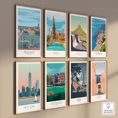 Collection of framed travel posters featuring Penzance, Seville, Iceland, Positano, New York, Amsterdam, Paris, and Lisbon.