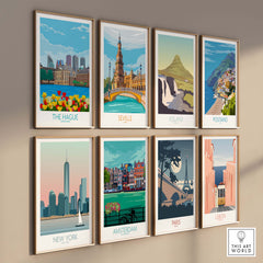 Colorful travel posters on a wall featuring The Hague, Seville, Iceland, Positano, New York, Amsterdam, Paris, and Lisbon.