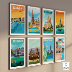 Collection of vintage travel poster art featuring various cities including Dublin, Barcelona, and New York framed on a wall.