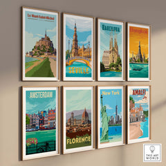 Collection of vintage travel posters including Le Mont Saint Michel, Barcelona, and New York, displayed stylishly on a wall.