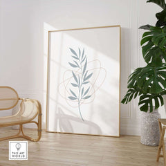 Modern leaf art print framed in a bright room with greenery, perfect for stylish nature wall decor.