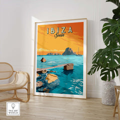 Ibiza Print Spain Sunset Poster featuring vibrant ocean scene with sailboat and rocky shore in a stylish framed setting.