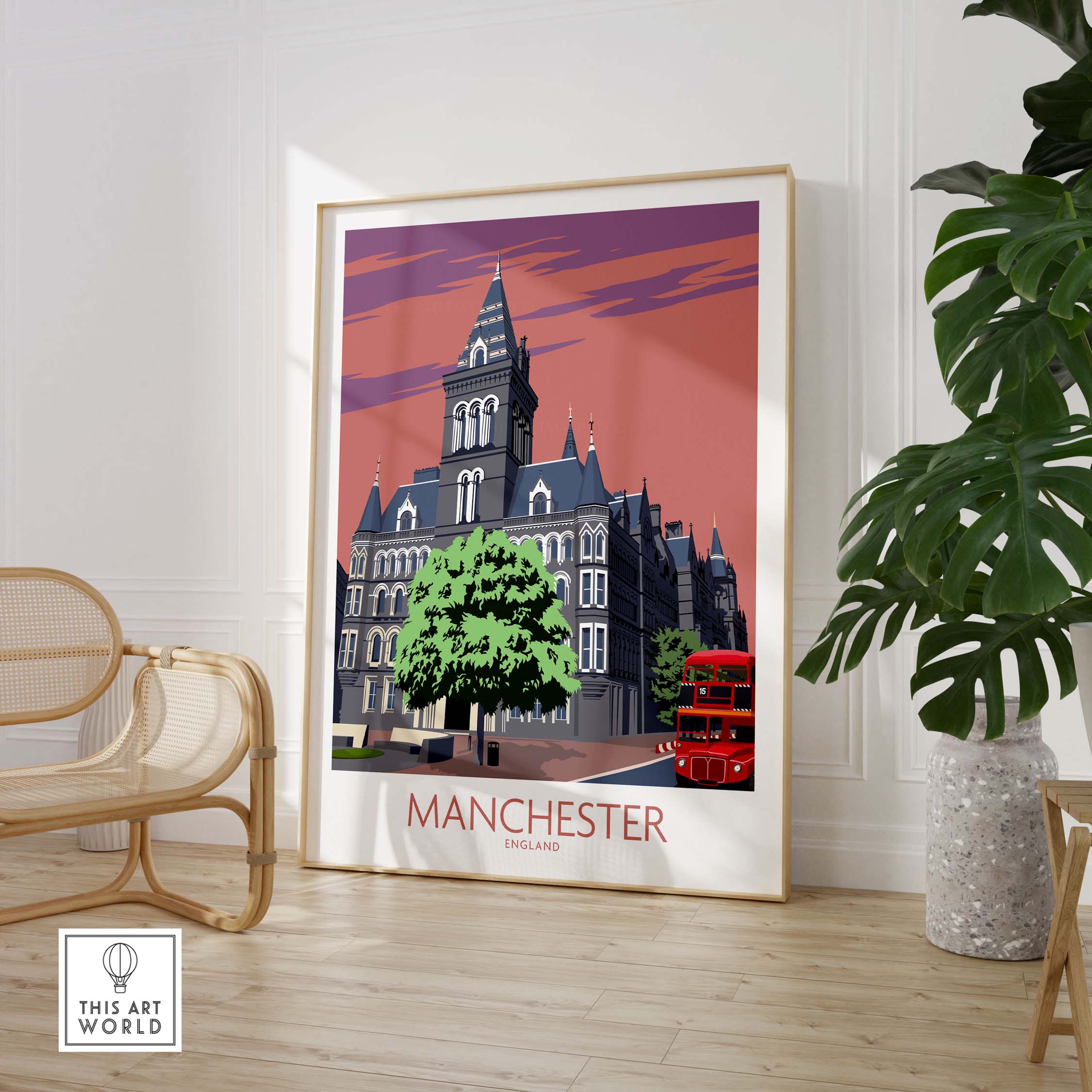 Manchester art print featuring vintage style architecture and a red double-decker bus, showcased in a stylish interior setting.