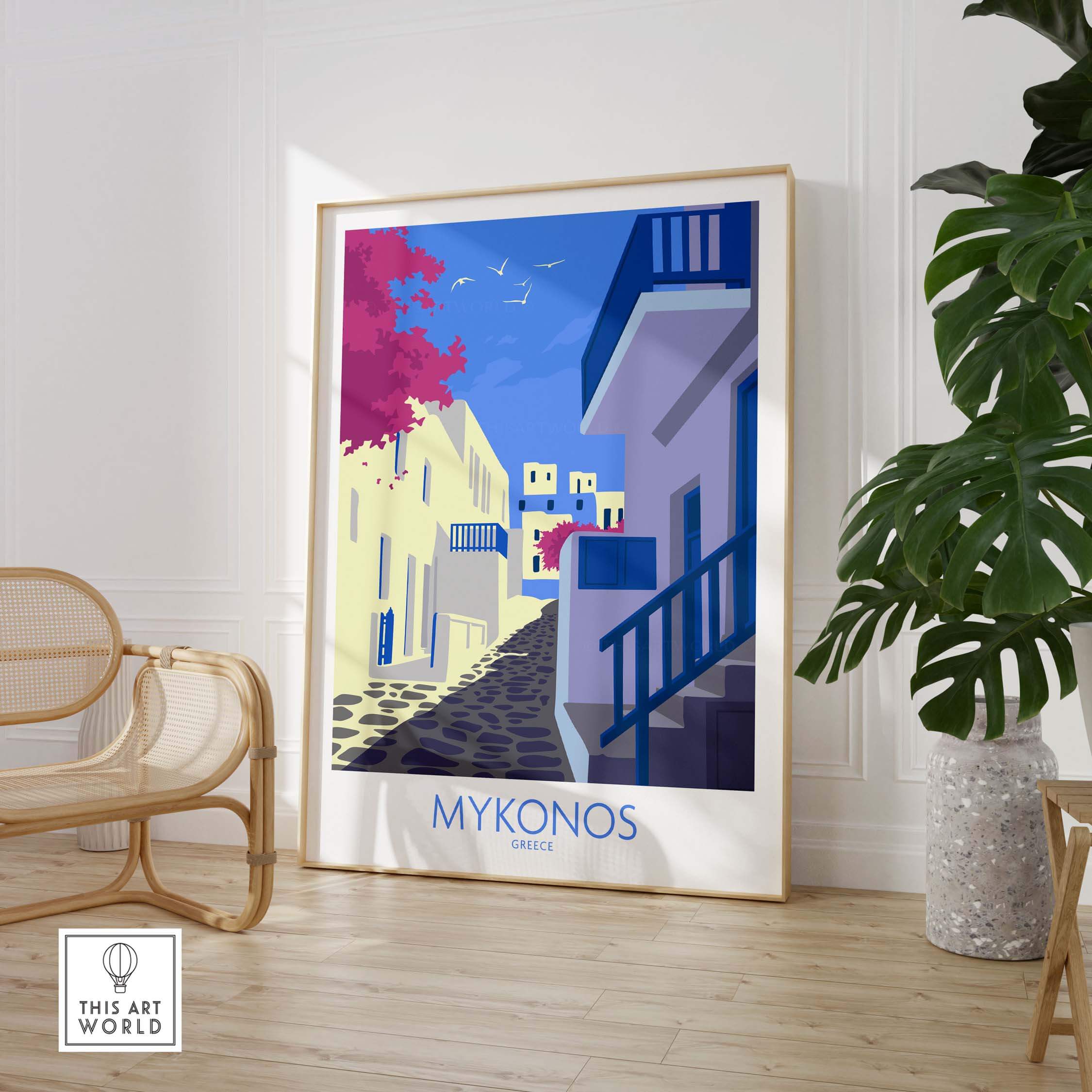 Mykonos print travel poster in a stylish frame, showcasing a vibrant street scene with blue and white buildings.