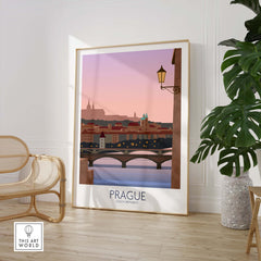 Prague Print Travel Poster showcasing a scenic view of the city at dusk, framed and displayed indoors.