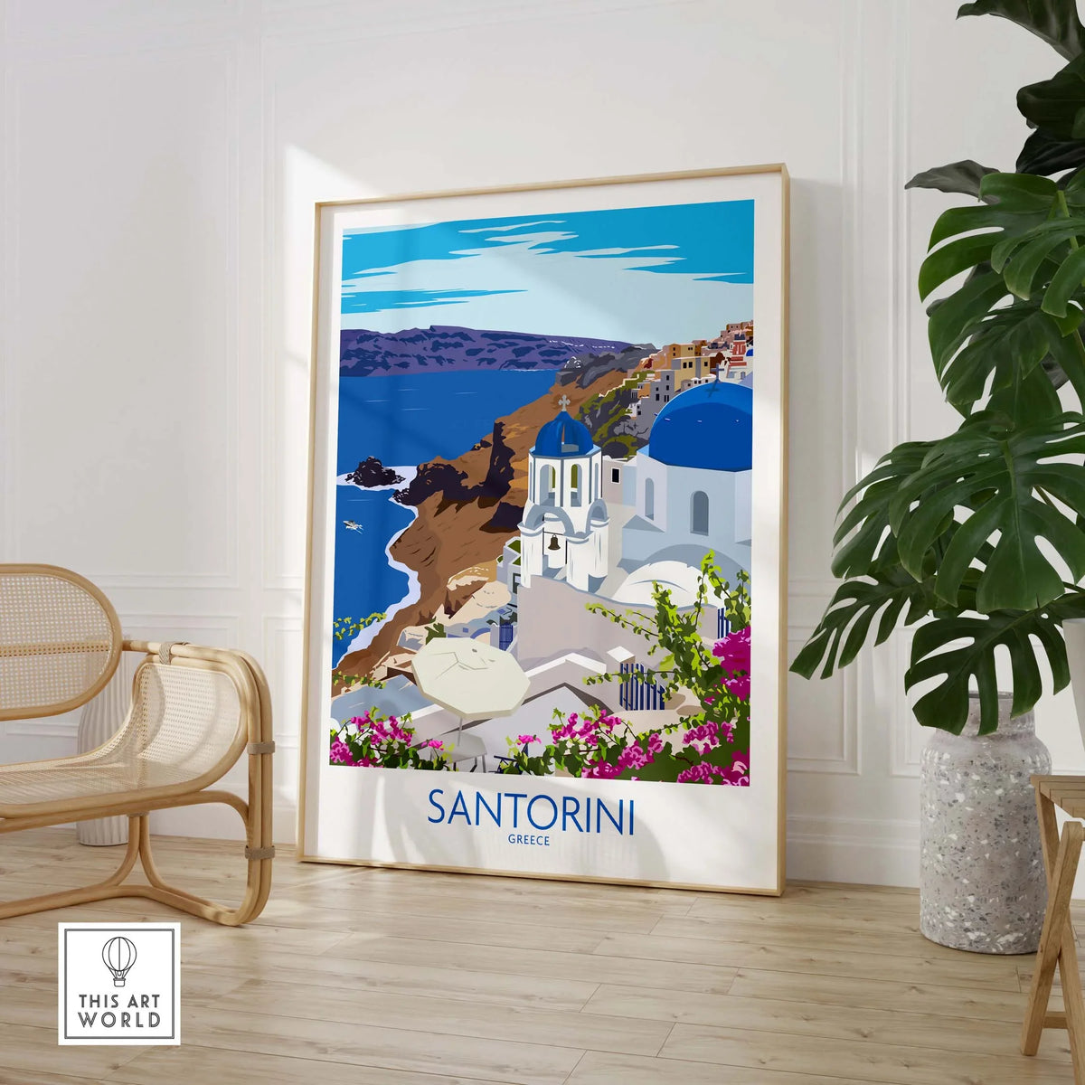 Stylish Santorini print travel poster displayed in a bright living room, showcasing iconic Greek architecture and coastal scenery.