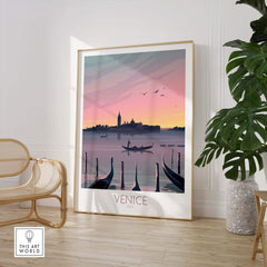 Venice print travel poster showcasing a romantic sunset over gondolas and the city skyline, framed and displayed in a stylish interior.