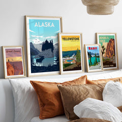 Alaska poster wall art print showcased among framed nature prints on a stylish bed with decorative pillows.