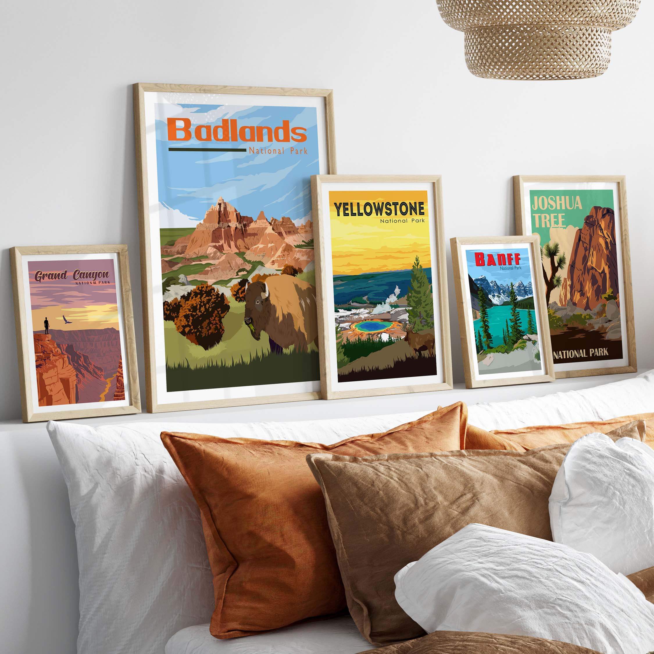 Collection of vintage National Park posters displayed on a wall above a stylish couch with decorative pillows.