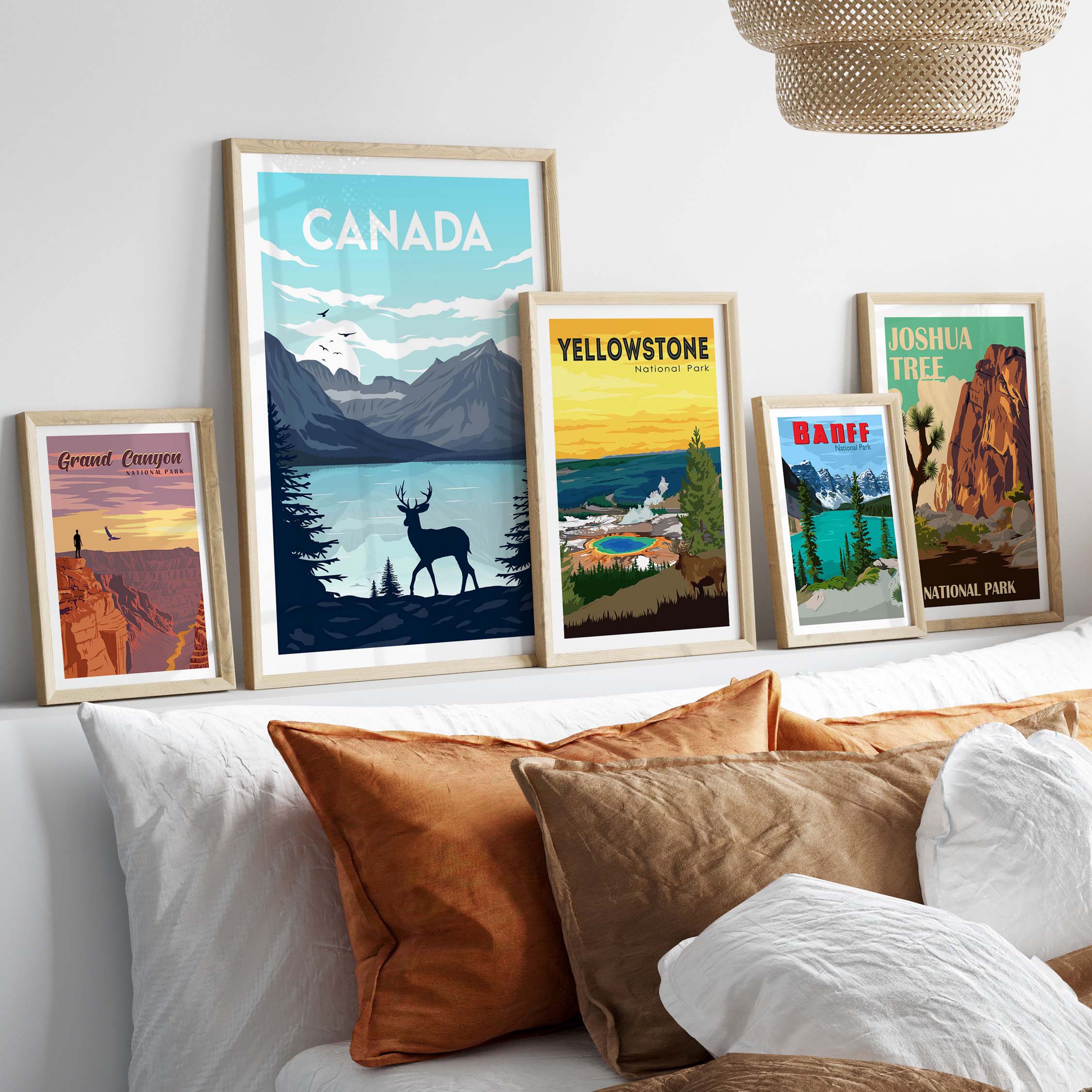Framed Canada and National Park posters displayed on a stylish wall above a cozy bed with decorative pillows.