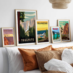 Display of framed Yosemite National Park and vintage national park prints on a stylish home decor shelf.