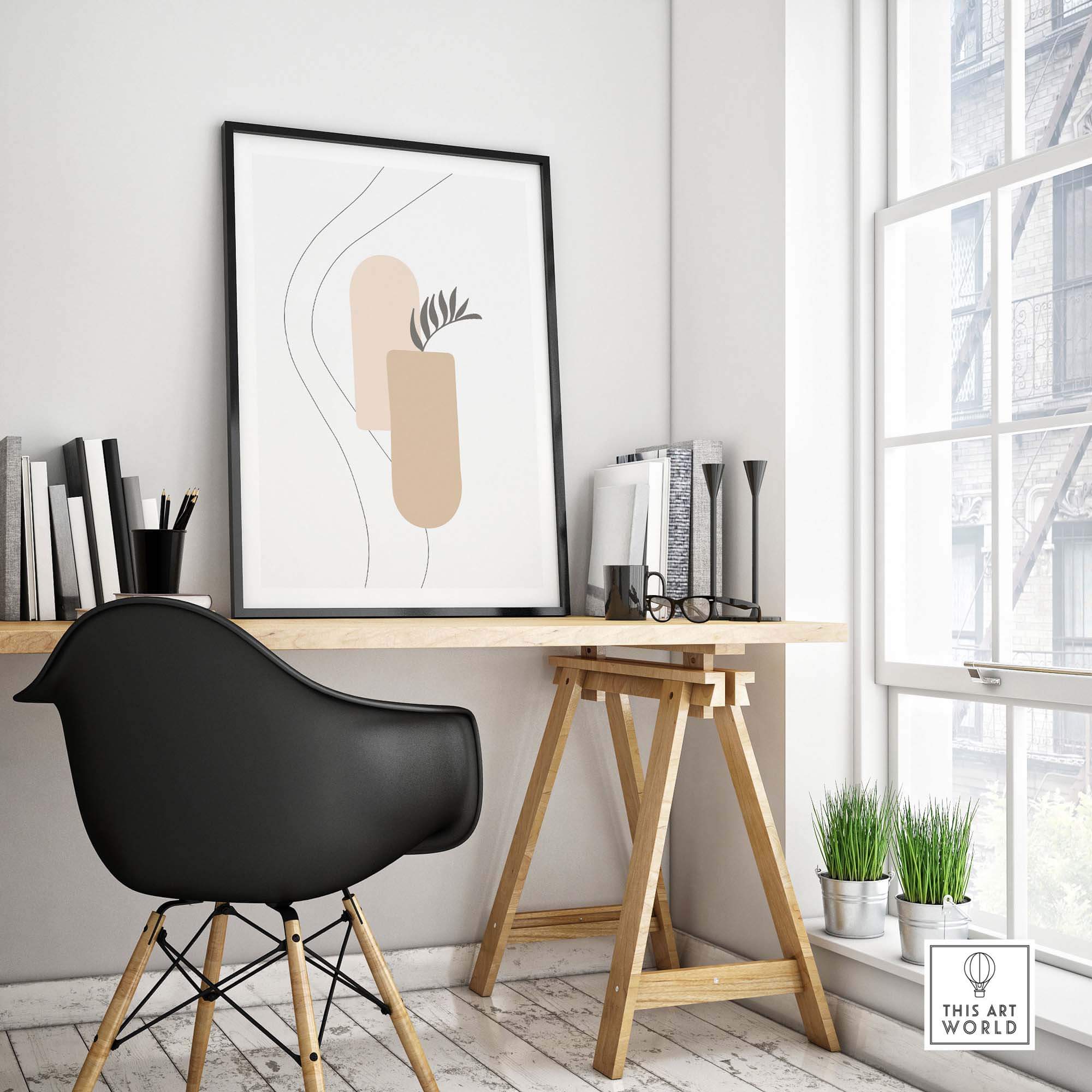 Stylish workspace featuring a Palm Leaf Print art piece, modern decor with a black chair and wooden desk.