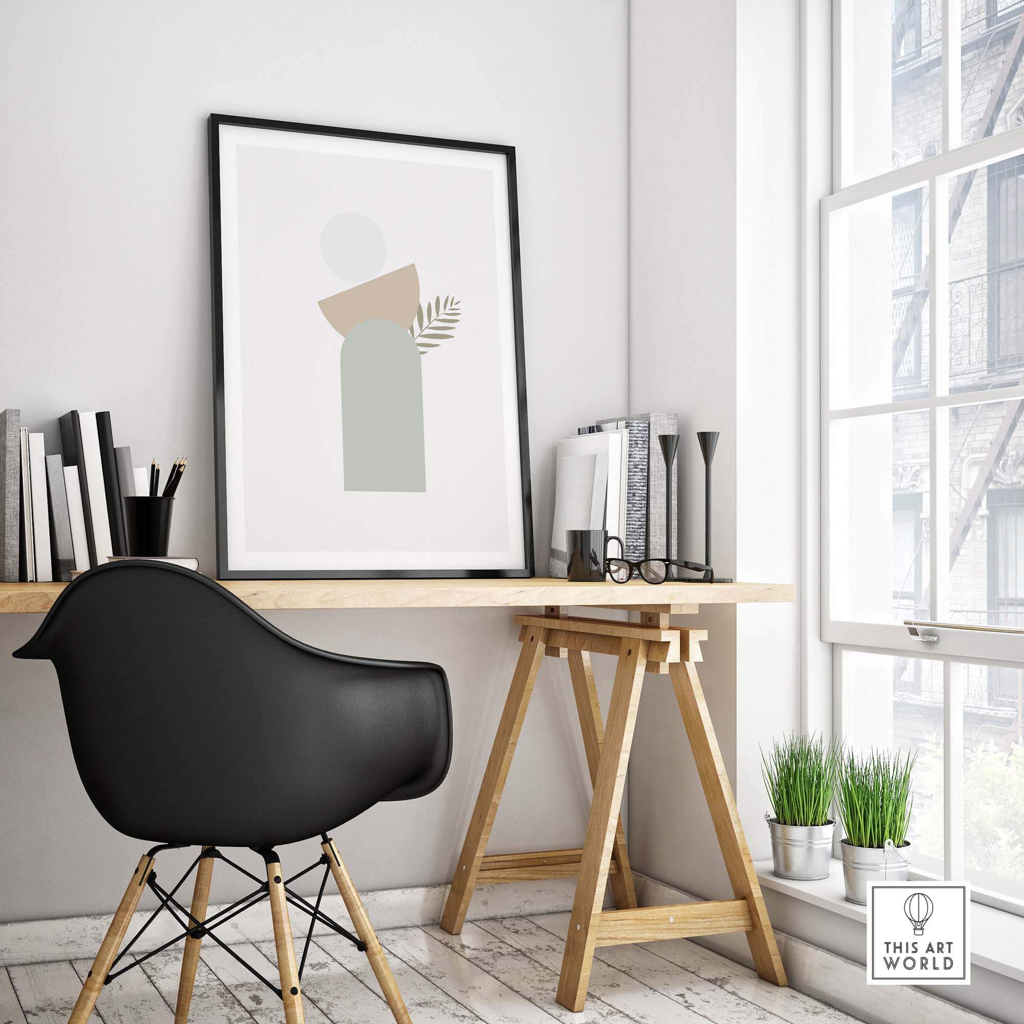 Modern abstract wall art featuring geometric shapes and green leaf design in a stylish workspace.
