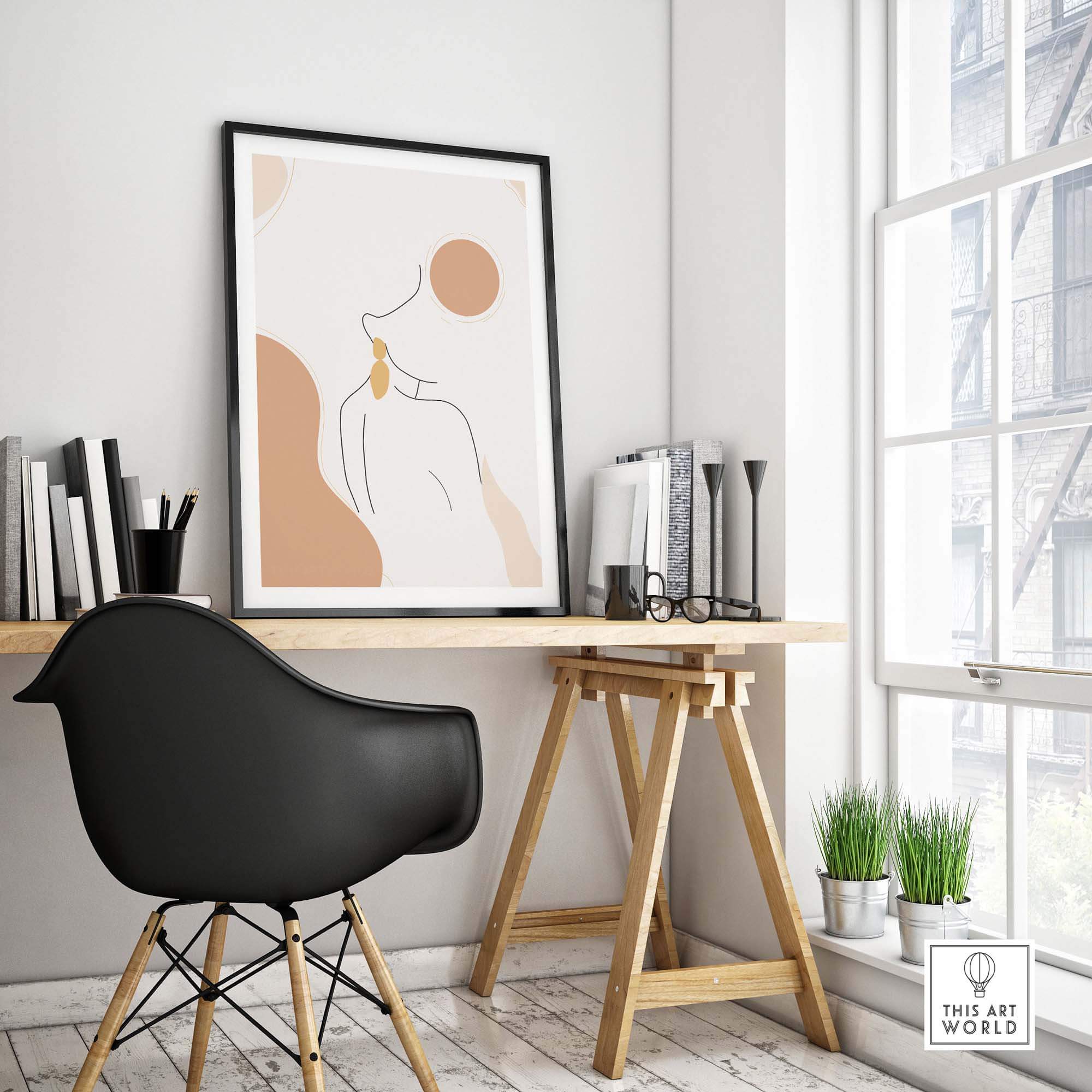 Modern abstract female outline print on a wall in a stylish office space with a black chair and wooden desk.