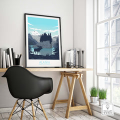 Alaska print travel poster featuring mountains, a moose, and a scenic lake, displayed in a stylish home office.