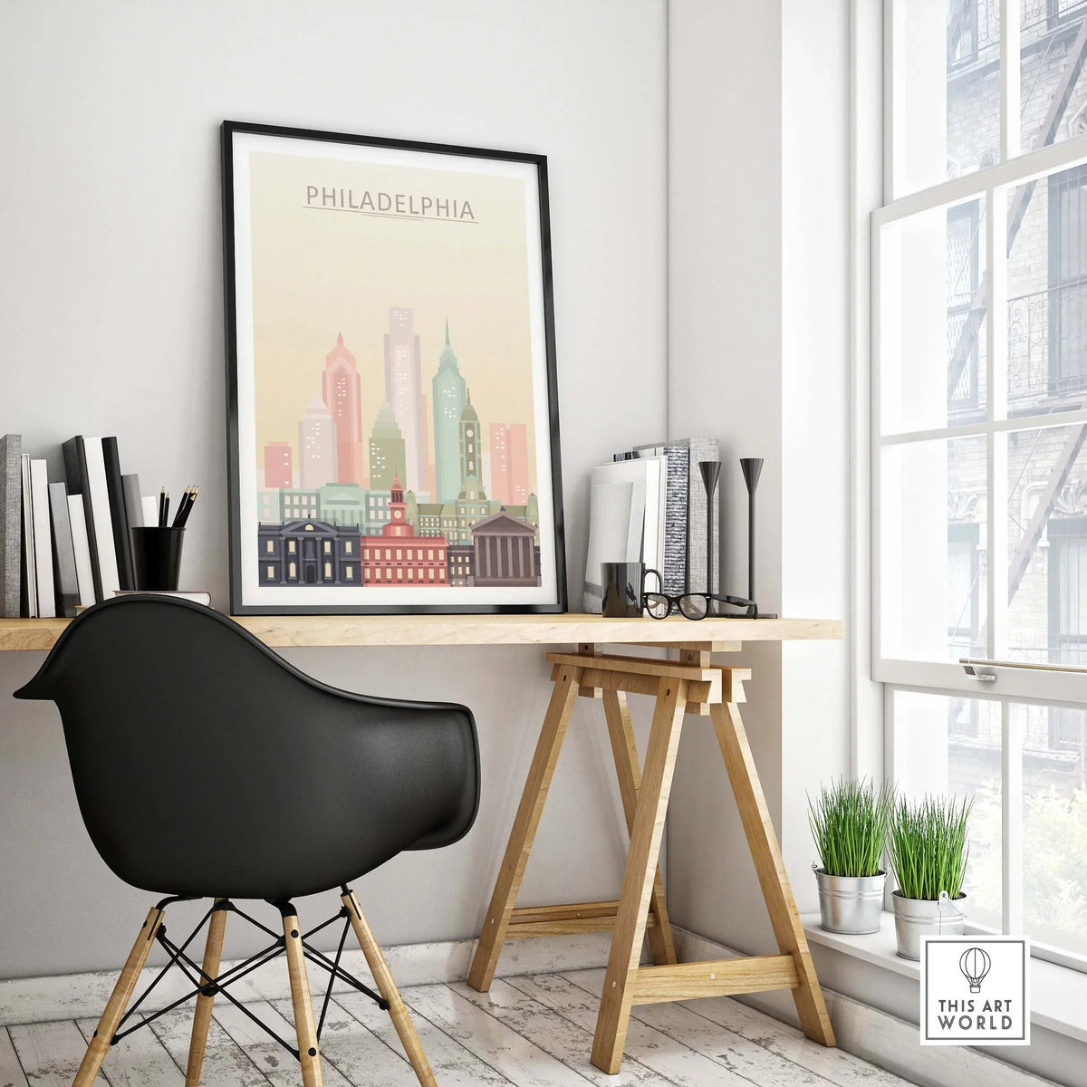 Philadelphia skyline poster framed in a stylish workspace, featuring warm pastel architectural details.