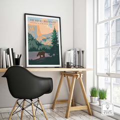Rocky Mountains Canada vintage print on wall in stylish office with bear and forest design, promoting outdoor wanderlust.
