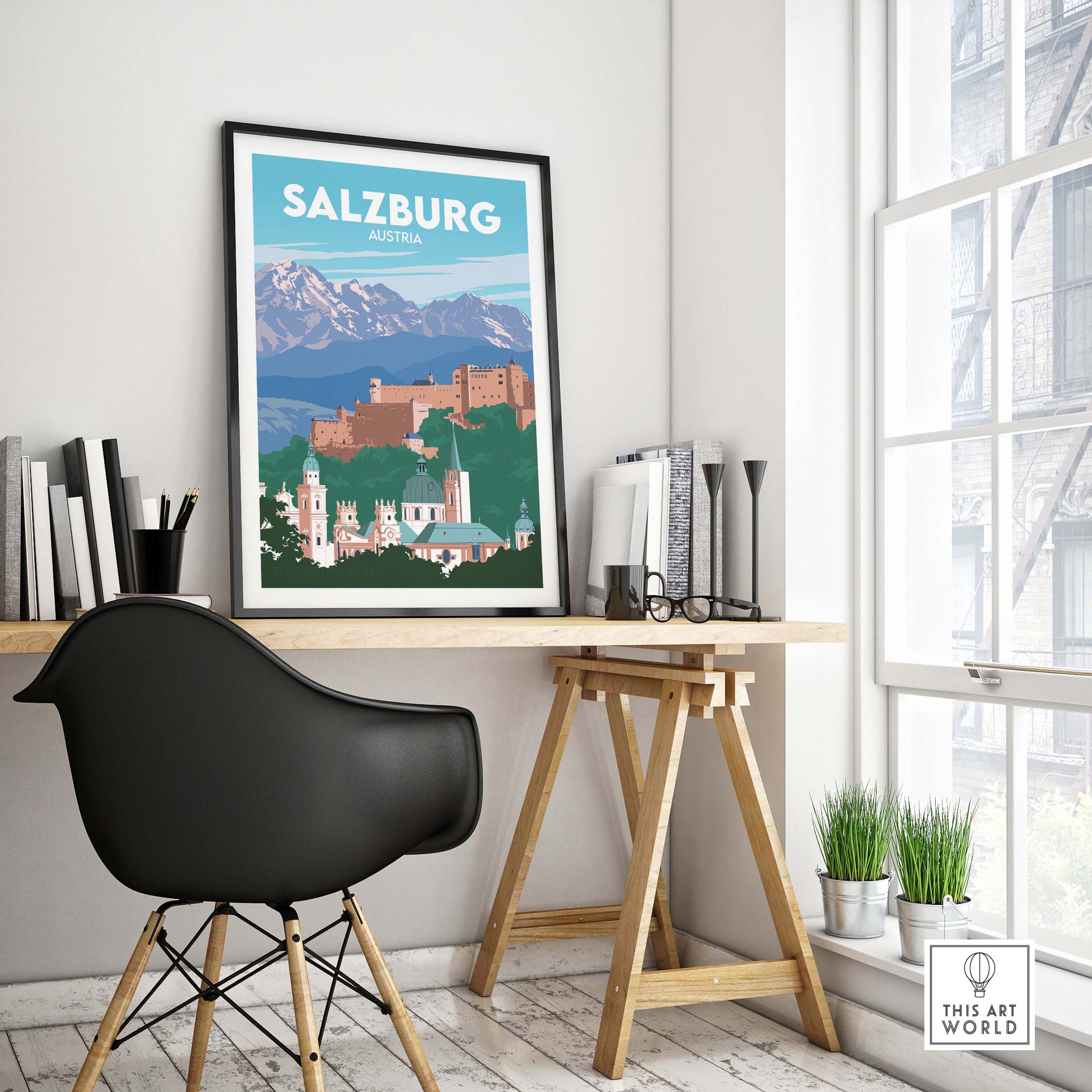 Salzburg travel poster print displayed in a modern workspace, featuring the iconic castle and mountains.
