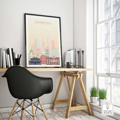 Shanghai skyline print featuring iconic architecture in pastel tones, displayed in a stylish workspace.