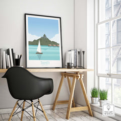 Tahiti Art Print Travel Poster displayed in a modern workspace with a sailboat and island scene.