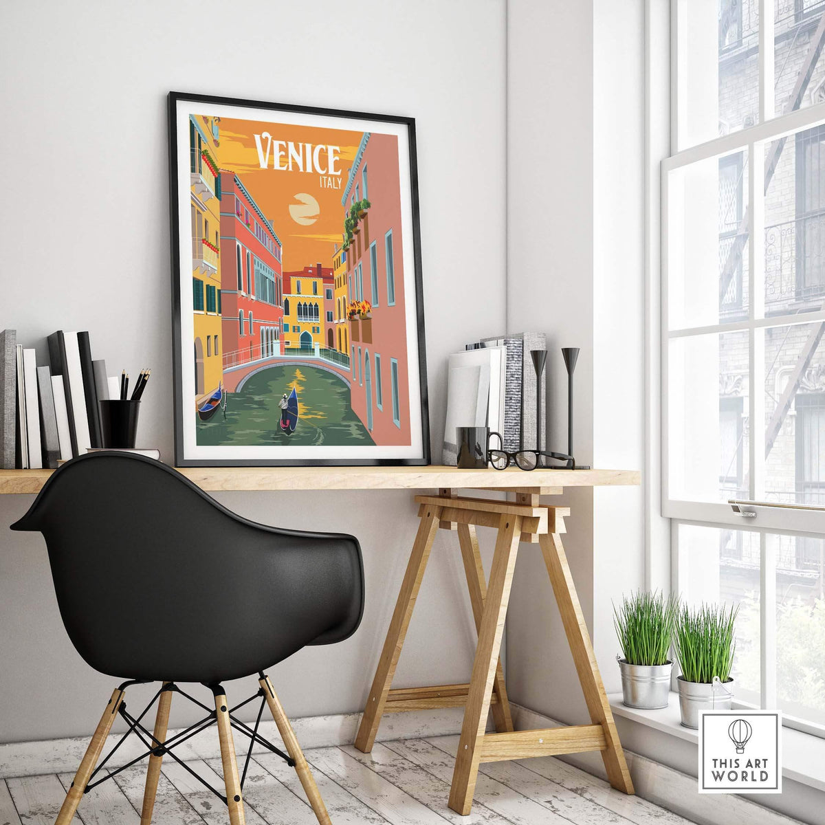 Framed Venice Italy poster print on a modern desk showcasing vintage travel art in a stylish interior setting.