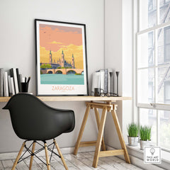 Zaragoza Spain poster displayed on a desk featuring a bridge and vintage art style, ideal for home or office decor.
