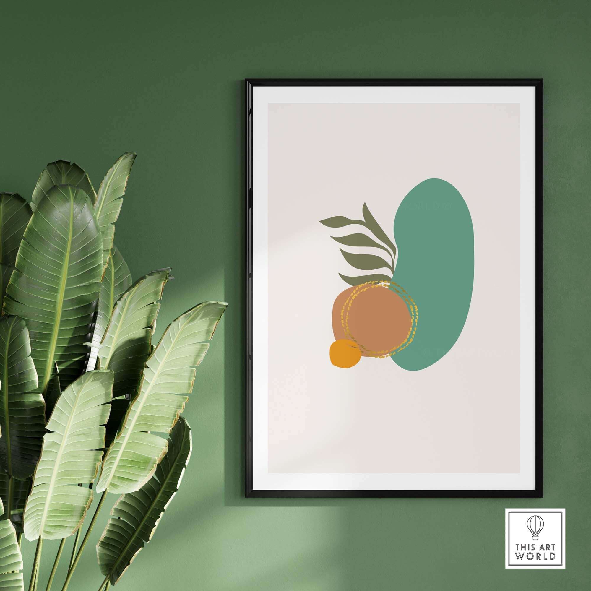 Mid Century wall art featuring abstract shapes and leaves, framed against a green wall, adding modern decor.