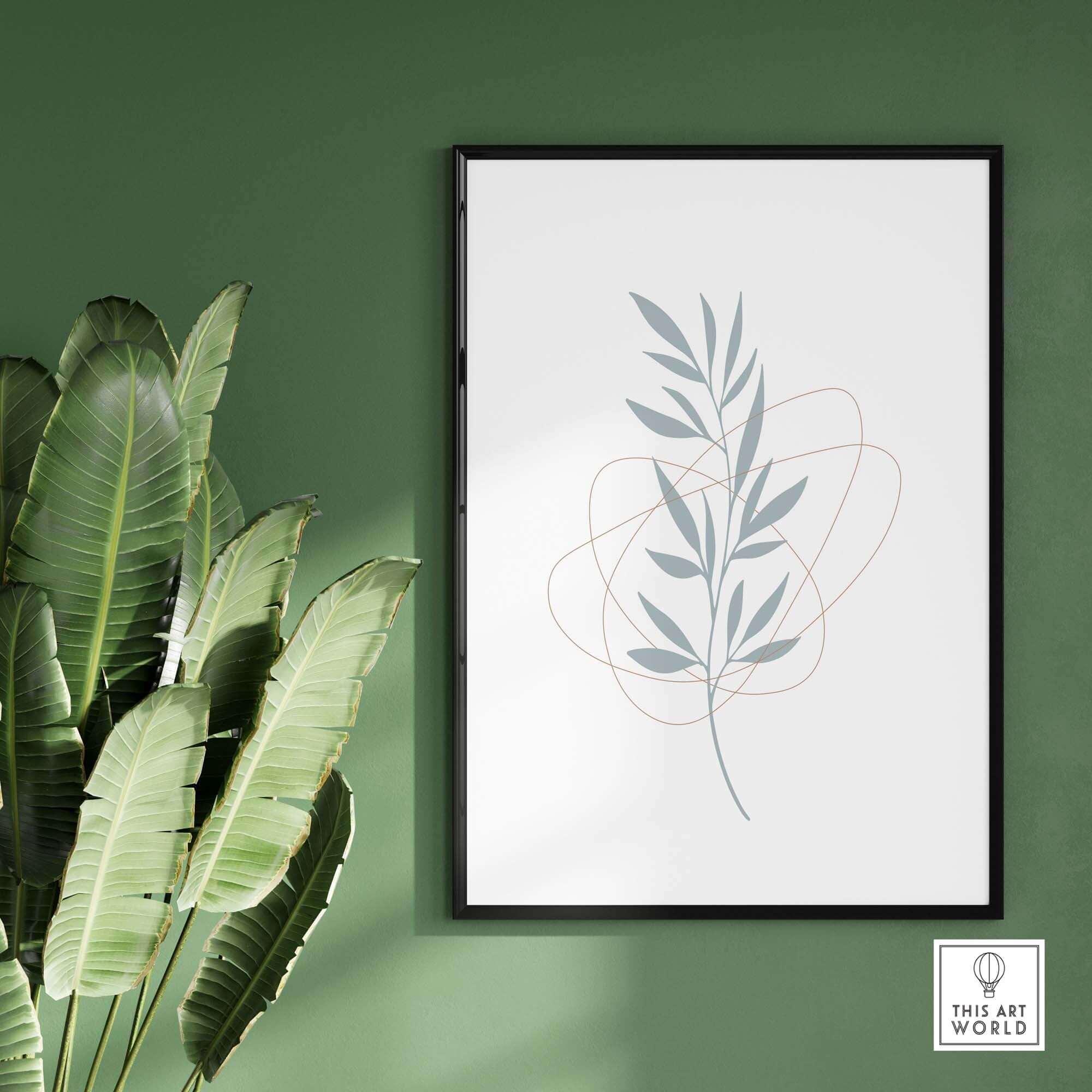 Leaf art print on a green wall, framed artwork with a modern abstract leaf design and tropical plant in foreground.