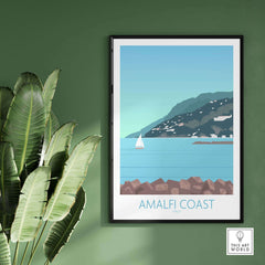 Framed Amalfi Coast print on a green wall, showcasing a serene coastal scene with a sailboat, perfect for home decor.