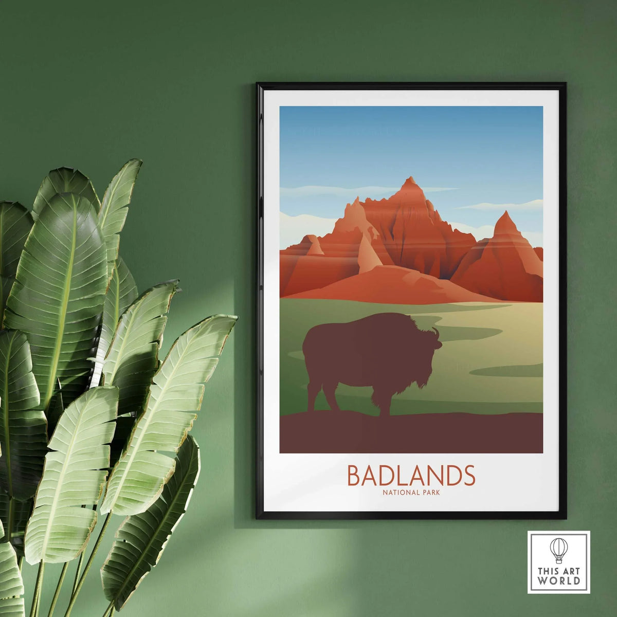 Badlands National Park art print featuring bison and colorful landscapes, framed on a green wall.