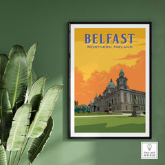 Framed Belfast Print Northern Ireland showcasing a vintage-inspired design against a green wall with tropical plants.
