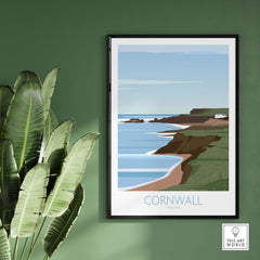 Cornwall poster print featuring coastal landscape art, framed on a green wall with a plant.