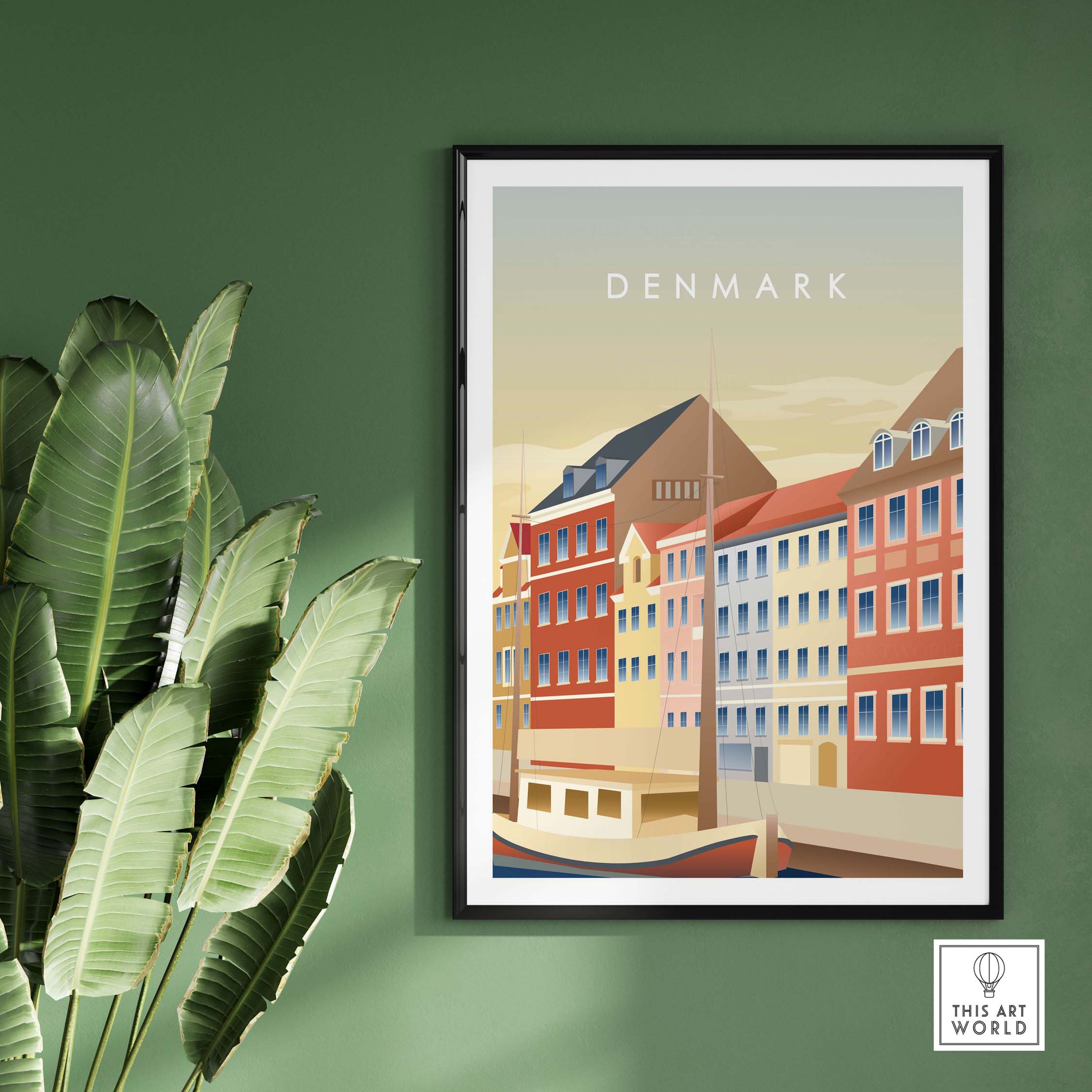 Denmark Wall Art Poster featuring colorful vintage-inspired buildings and a serene water view, framed on a green wall.
