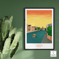 Leeds Print England Travel Poster framed, showcasing a vibrant scene of the city with a boat on the river.