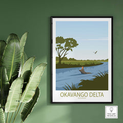 Okavango Delta Botswana vintage travel poster featuring serene river scene and wildlife, framed on a green wall.