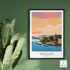 San Juan Puerto Rico vintage travel poster print framed on a green wall with tropical plants.