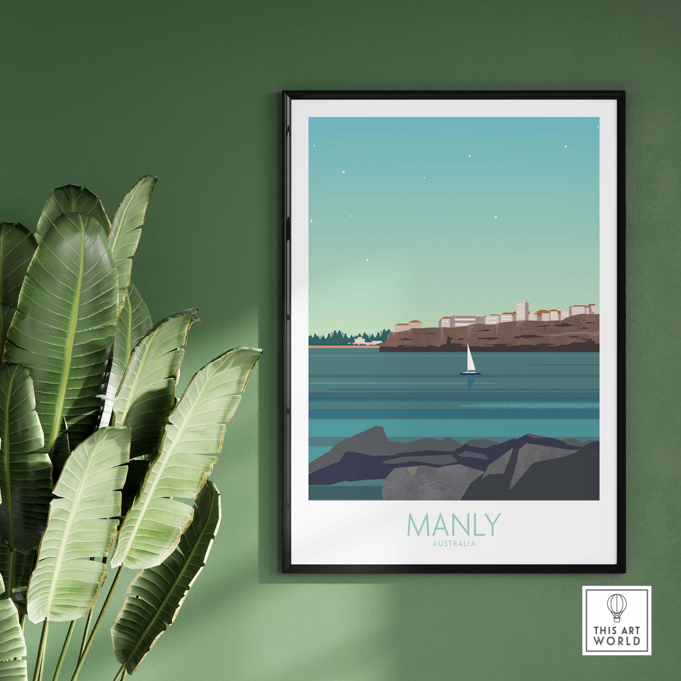 Framed Manly Australia travel poster featuring a sailboat and coastal scenery on a green wall.