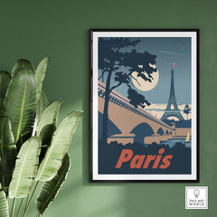 Vintage moonlit Paris poster with Eiffel Tower, framed on a green wall, showcasing travel nostalgia.