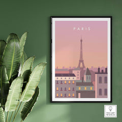 Paris Print Wall Art Poster featuring the Eiffel Tower in soft pastel colors, framed on a green wall with plants.