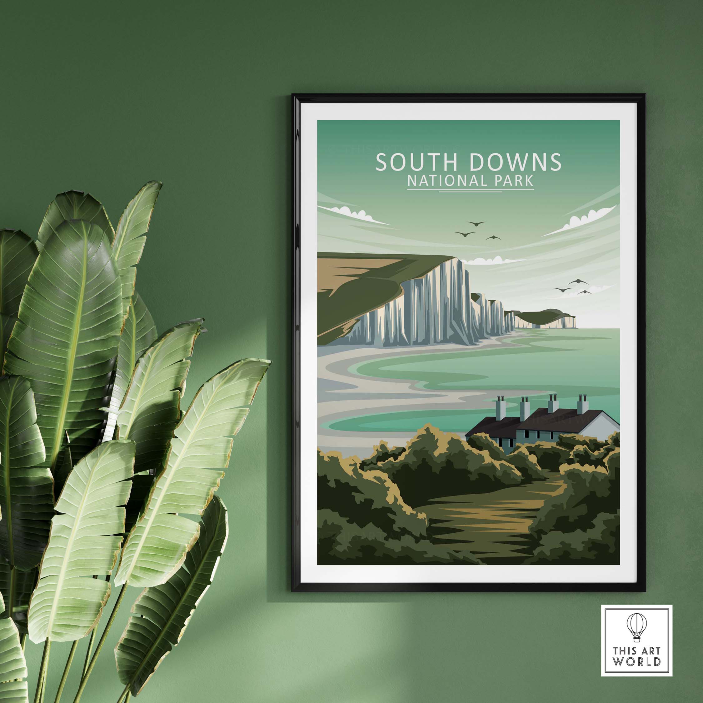 South Downs National Park poster framed on green wall, featuring coastal cliffs and lush landscape in minimalist style.